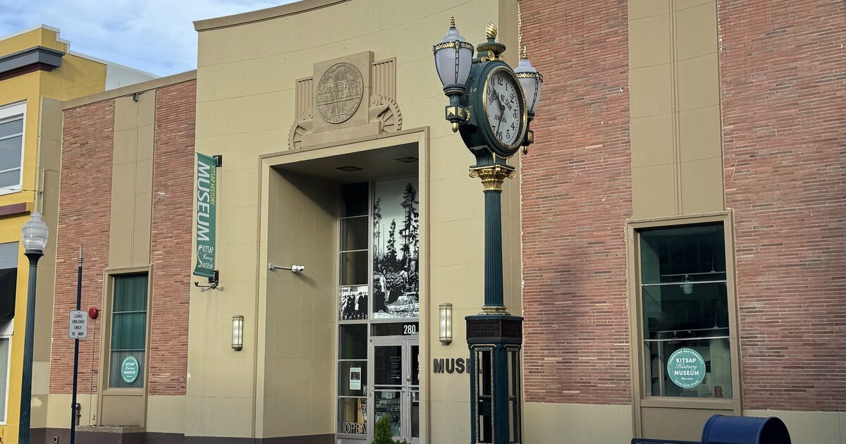 Front entrance of the Kitsap History Museum on 4th Street in downtown Bremerton, with the green street clock and museum banner