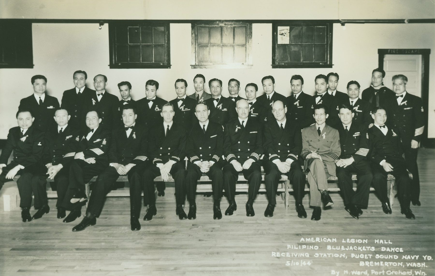 Formal group portrait of Filipino Navy bluejackets and officers seated in rows