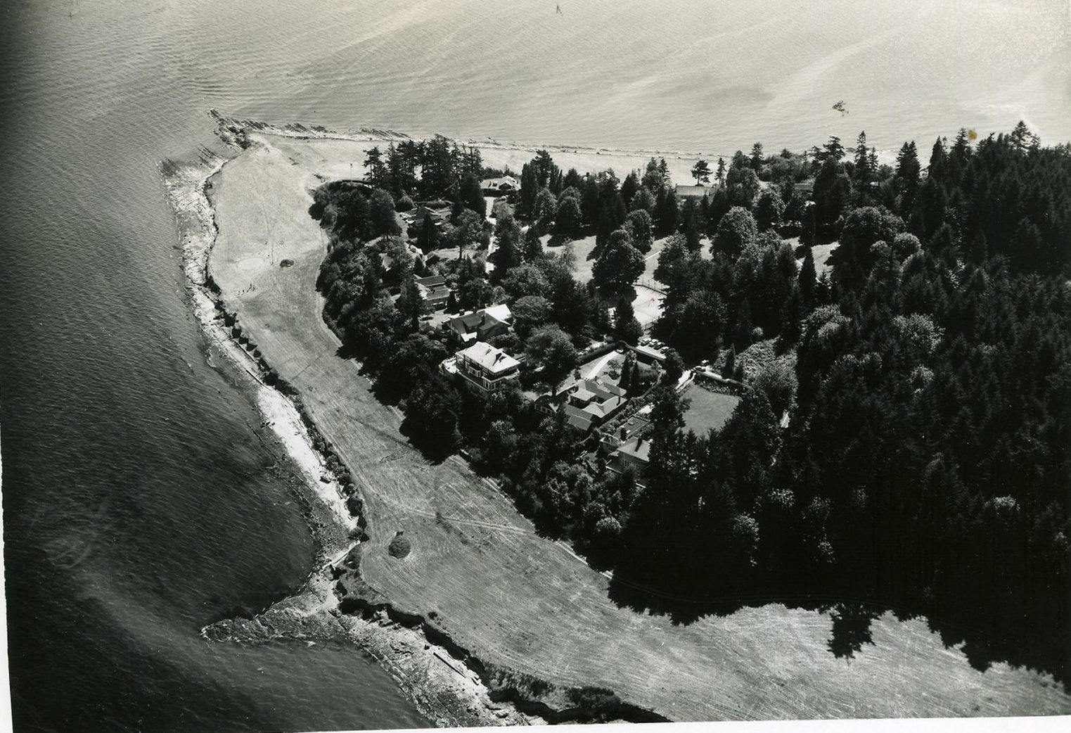 Aerial photograph of Restoration Point, a long sandy spit and wooded point at the southeast tip of Bainbridge Island