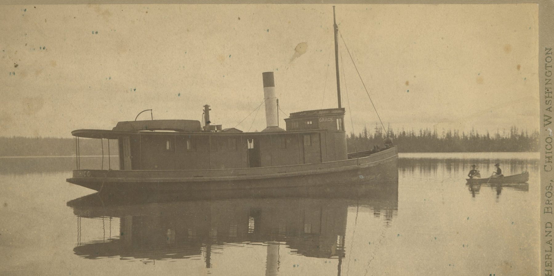 The small steamer Grace on calm water, with a smokestack and a covered deck